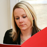 Photo of a community-based mental health counselor, concerned and looking at a folder